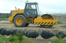 Baled tyres being laid